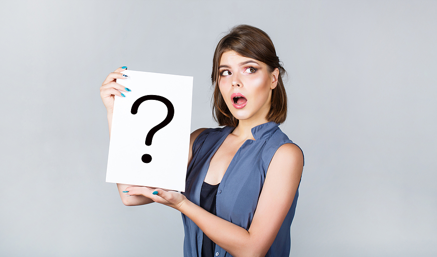 Girl Question. Woman With Doubtful Expression And Question Marks