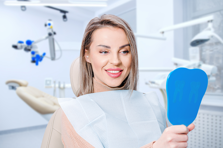 Happy Attractive Woman Looking At Her Teeth In Mirror. Satisfied